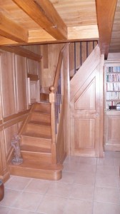 Escalier à noyau integré dans une boiserie assemblée, chêne vernis